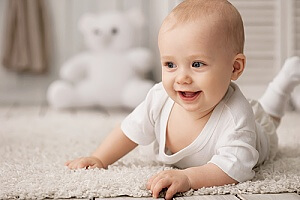 an infant laying on carpet that is safe for babies